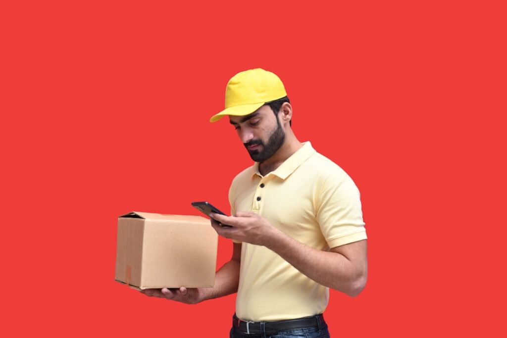 Um Homem Em Um Capacete Amarelo Olhando Para Um Telefone F25wdi2udek