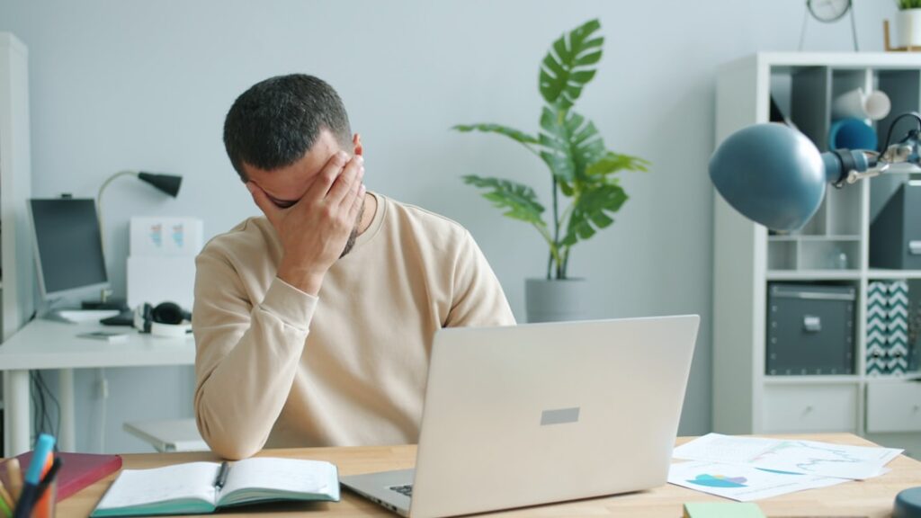Homem Esfregando O Rosto Na Frente Do Laptop bl7h_R PKpU