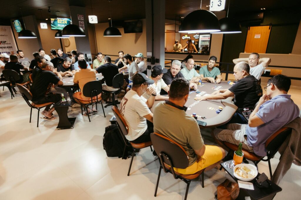 A vibrant poker game with participants intensely focused in a casino setting.