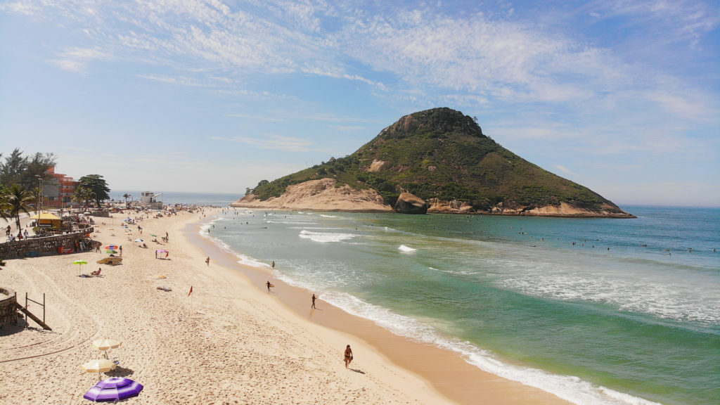Stunning aerial view of Recreio Beach, Rio de Janeiro, with tourists enjoying a sunny day.